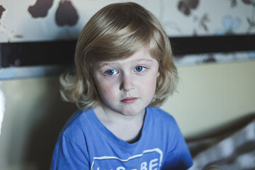 Cute five years old blonde boy with blue eyes and different emotions facial expression. Portrait. Emotions on the face of baby.