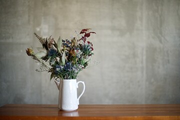 アンティークの水差しと生花の渋い花束