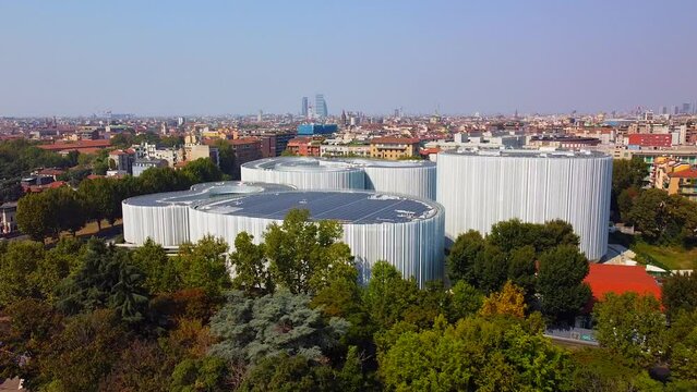 Aerial view of solar panels on the roof. The new campus of the SDA Bocconi School of Management is a modern building with classrooms. Autumn trees. Ecological energy. Milan Italy 11.2022