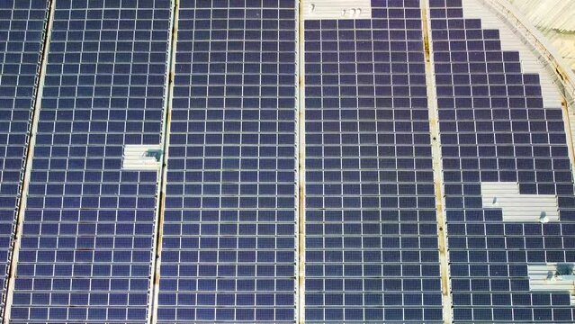 Aerial view of solar panels on the roof. The new campus of the SDA Bocconi School of Management is a modern building with classrooms. Autumn trees. Ecological energy. Milan Italy 11.2022