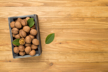 Fresh walnuts on wooden background, top view