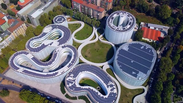 Aerial view of solar panels on the roof. The new campus of the SDA Bocconi School of Management is a modern building with classrooms. Autumn trees. Ecological energy. Milan Italy 11.2022