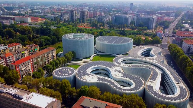 Aerial view of solar panels on the roof. The new campus of the SDA Bocconi School of Management is a modern building with classrooms. Autumn trees. Ecological energy. Milan Italy 11.2022