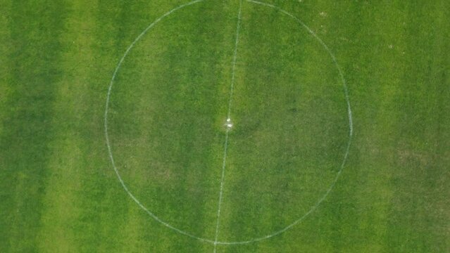 Drone footage of  center of soccer field or football field. 