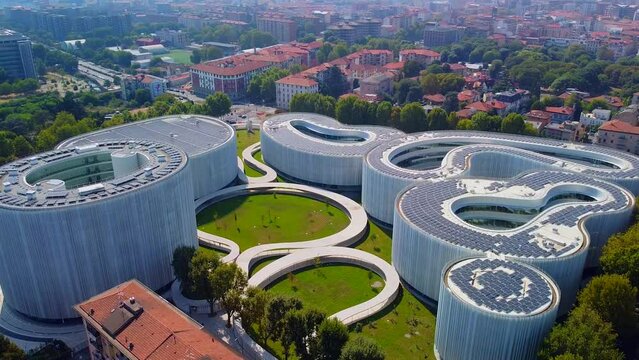 Aerial view of solar panels on the roof. The new campus of the SDA Bocconi School of Management is a modern building with classrooms. Autumn trees. Ecological energy. Milan Italy 11.2022
