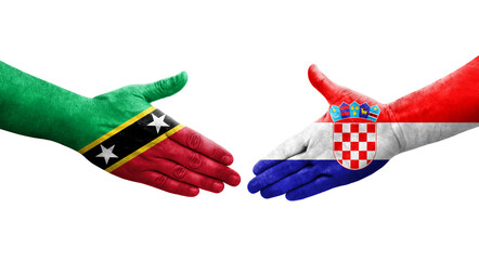 Handshake between Croatia and Saint Kitts and Nevis flags painted on hands, isolated transparent image.