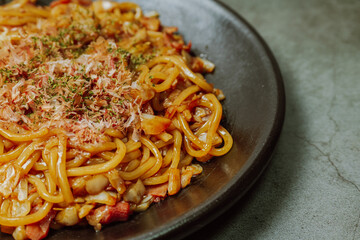 Delicious yakisoba dish on a black plate