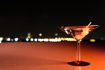 A glass of whiskey served on a bar with an out of focus view of the night city. Drinks and spirits and copy space. 3d illustration.
