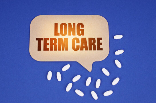 On the blue surface of the tablet and a cardboard plate with the inscription - LONG TERM CARE
