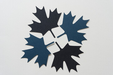 four paper leaves on blank paper