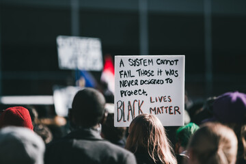 Sign saying black lives matter surrounded by a crowd in Alberta