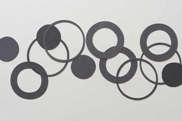 gray paper dots, circle, and ring shapes on blank paer