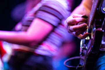 girl band playing guitar in a gig