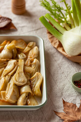Baked fennel on a kitchen table, side view