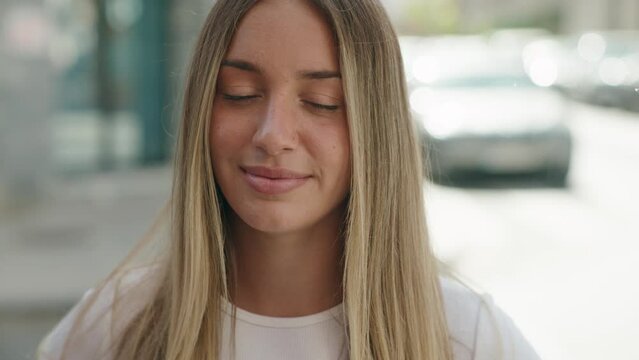 Young beautiful hispanic woman smiling confident standing at street