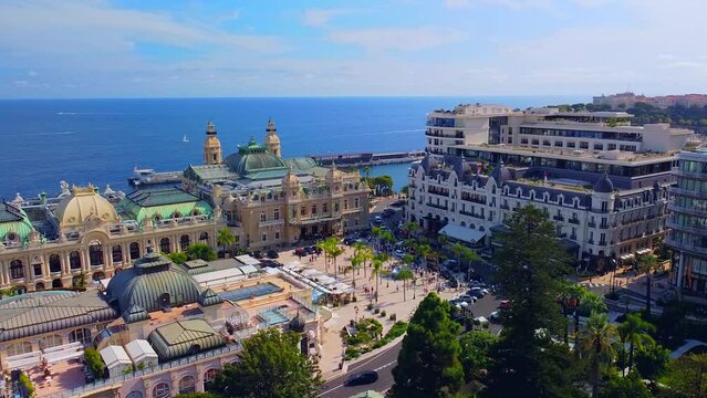Aerial view of the old casino. area with palm trees. Luxurious super cars in front of the hotel. Monument and fountain. Modern architecture of the kingdom of MONTE CARLO, MONACO SEPTEMBER 2022