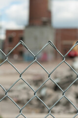 chain link fence with old industrial complex behind