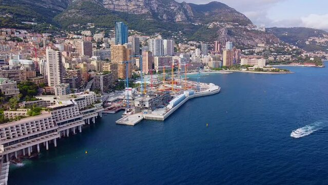 Aerial view of the old casino. area with palm trees. Luxurious super cars in front of the hotel. Monument and fountain. Modern architecture of the kingdom of MONTE CARLO, MONACO