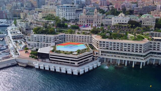 Aerial view of the old casino. area with palm trees. Luxurious super cars in front of the hotel. Monument and fountain. Modern architecture of the kingdom of MONTE CARLO, MONACO