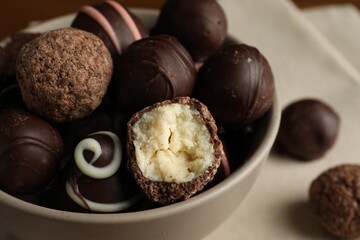 Bowl with many different delicious chocolate truffles, closeup