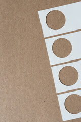 paper business cards with holes on cardboard