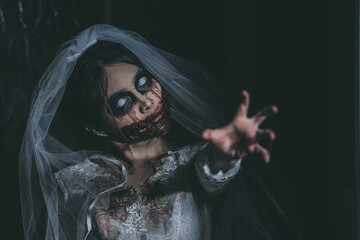 Portrait of asian woman make up ghost bride death and blood the horror is darkness scary horror...