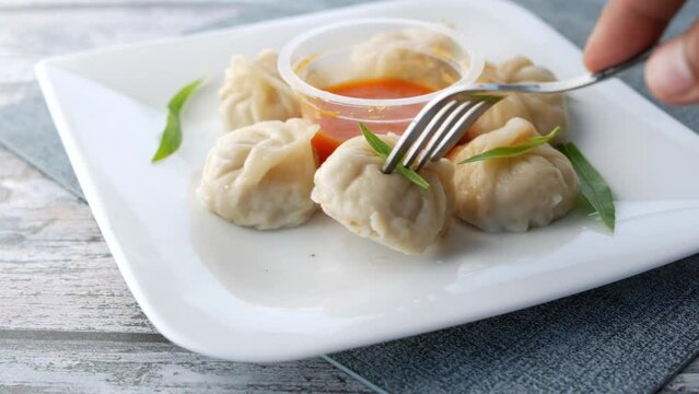 close up of chicken momo dumpling on a plate 