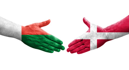Handshake between Denmark and Madagascar flags painted on hands, isolated transparent image.