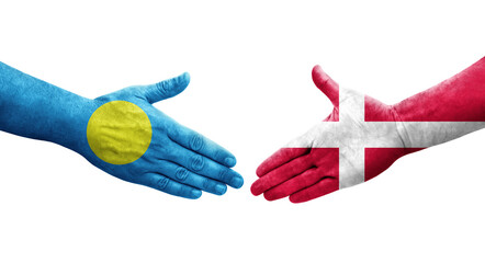 Handshake between Denmark and Palau flags painted on hands, isolated transparent image.