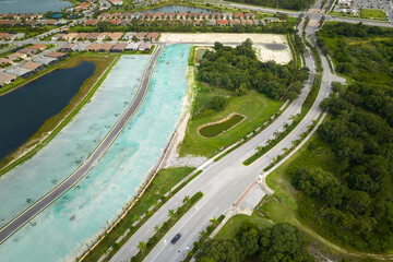 Aerial view of real estate development with tightly located family houses under construction in Florida closed suburban area. Concept of growing american suburbs