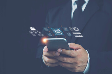 Hand with document icons and typing to laptop computer an using phone, Online documentation database and document management system concept. Process automation to efficiently manage files. 