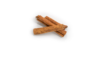 Isolated dried cinnamon sticks, top view image of dried cinnamon on white background. Three different shapes of cinnamon sticks.