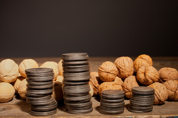 Walnut and silver coins. Nuts on a wooden table.