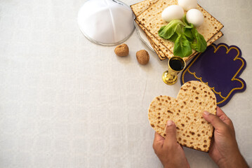 man's hands holds Matzah shape of heart. Traditional of Jewish Holiday on Passover. Home symbol of lovely family. top view, layout. love and care. Gift for lovers. Feeling in love and blissful life