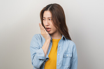 Portrait of pretty brunette hair, disgust smell bad strong asian young woman, girl checking her...