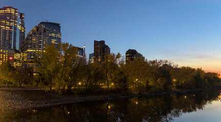 Fototapeta na wymiar Calgary's cityscape reflected in the river water at dusk.