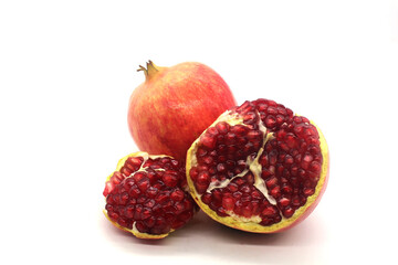 Fresh pomegranate fruits isolated against a white background

