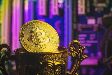 Cryptocurrency concept , Golden bitcoin on winners cup background mainboard , The future of money....