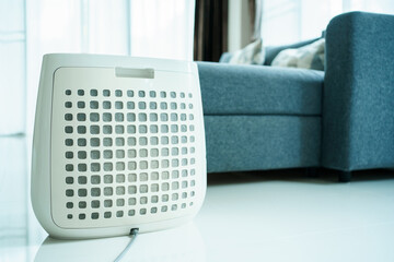 Dirty - dusty air purifier filter in living room. Air purifier machine lid or grille filter fully...