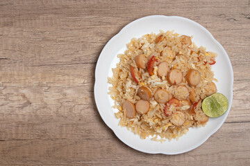 Sausage fried rice with egg and vegetables in white plate