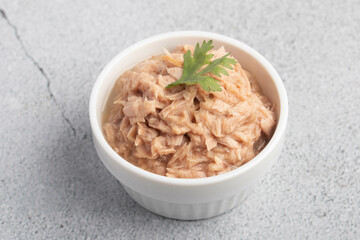 canned tuna in a white cup on a white background