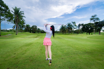 Professional woman golfer teeing golf in golf tournament competition at golf course for winner	