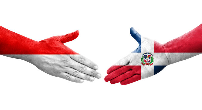 Handshake between Dominican Republic and Indonesia flags painted on hands, isolated transparent image.