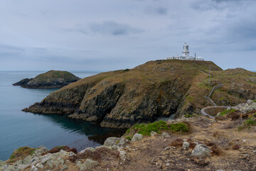 landscape view of the Pembrokeshire coast with the historic Strumble Head Lighthouse