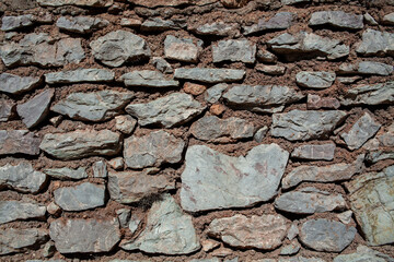 Old stone wall texture background. Rough stone wall. Big rough stones fence