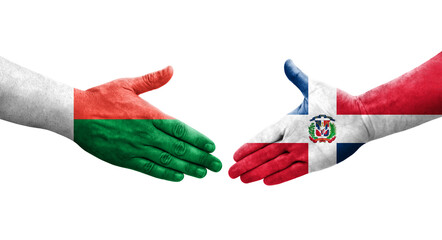 Handshake between Dominican Republic and Madagascar flags painted on hands, isolated transparent image.