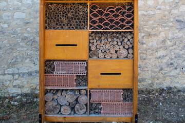 Fototapeta na wymiar insect hut hotel french text in wooden house for butterfly bee and animals