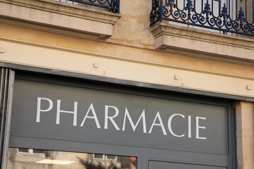 Fototapeta na wymiar french text pharmacie mean pharmacy sign wall building facade entrance