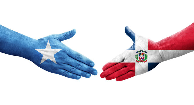 Handshake between Dominican Republic and Somalia flags painted on hands, isolated transparent image.