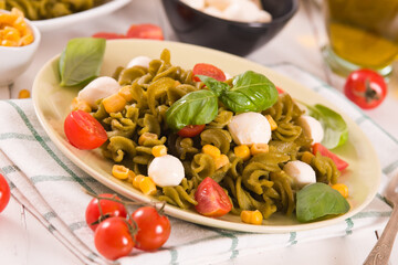 Fusilli pasta with cherry tomatoes and sweet corn.